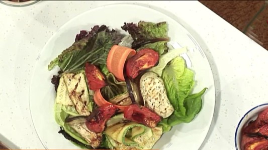 Ensalada de vegetales asados, hojas verdes y tomates asados